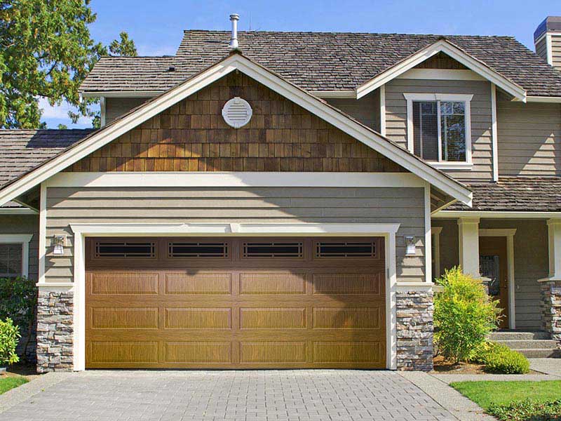 brown garage door that perfectly matches brown shake shingle siding