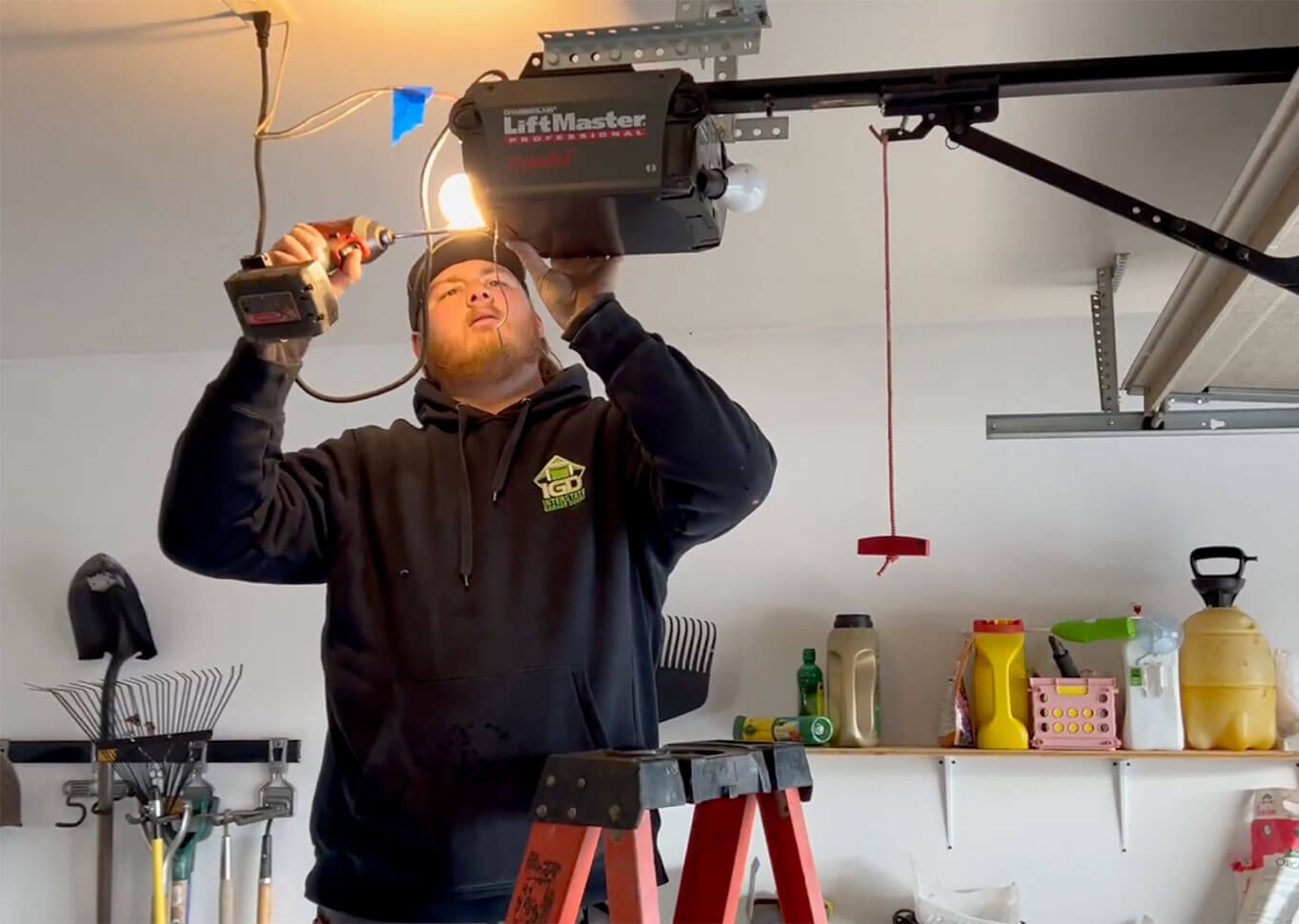 technician working with a screw gun to fix a Lift Master garage door motor