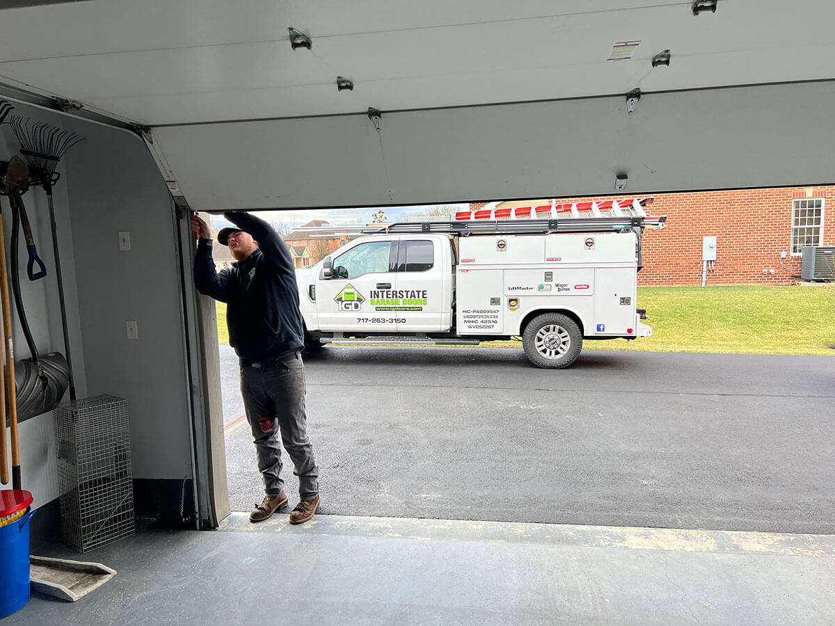 technician working on a garage door railing