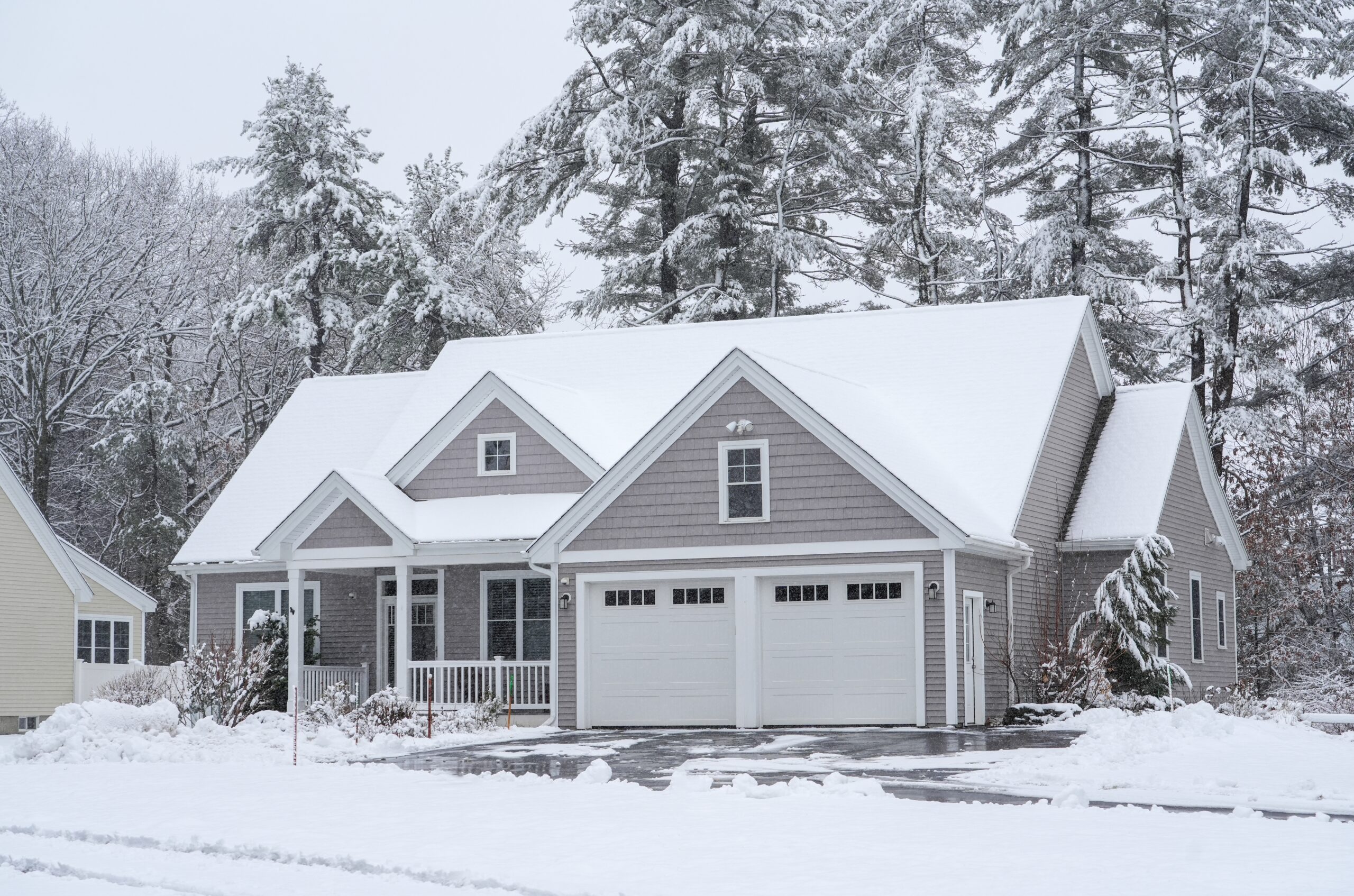 house in a residential community after a heavy snow that may cause garage door problems